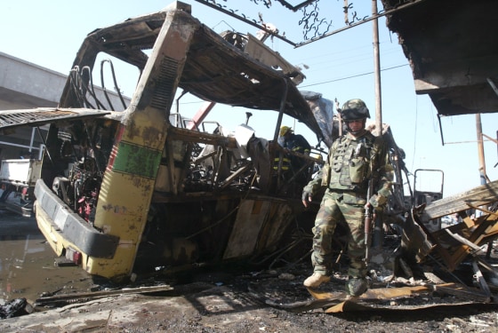 An Iraqi soldier inspects the site of Thursday's suicide attack at a Baghdad bus station.