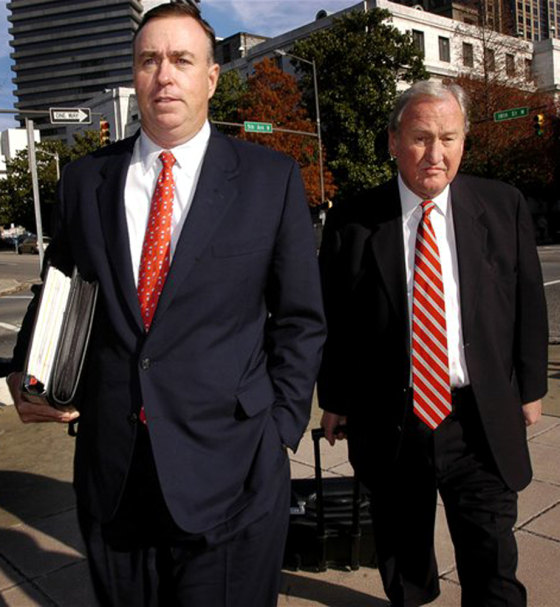 Bills Owens, left, former Healthsouth chief financial officer, walks to the federal courthouse in Birmingham, Ala., with his attorney Fred Helmsing Friday. Owens, who pleaded guilty to accounting fraud charges, was sentenced to five years in prison.
