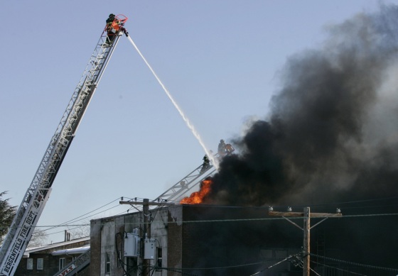 Firemen try to extinguish a fire at an apartment building in Bergenfield