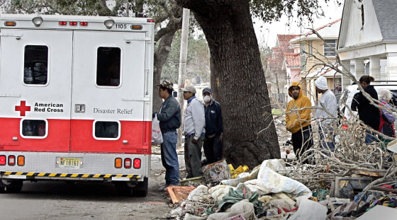 People line up Wednesday for food distributed by the American Red Cross in New Orleans. So far, end-of-year giving is generally reported strong, although some local charities remain worried because they have more needy people to serve. 