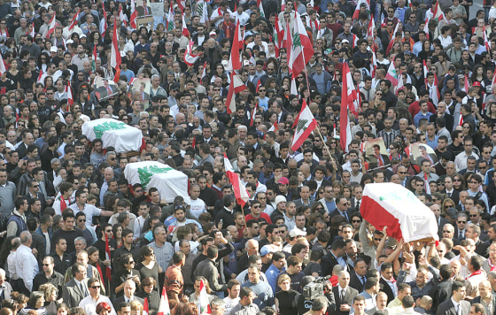 Lebanese mourners carry the coffins of s