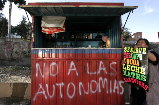 Aymara Indian street vendor Juana Ilasanca sets up her shop in the outskirts of La Paz, Bolivia. Calls for independence are becoming a major election issue as the country heads to the polls this Dec. 18. The graffitti reads "No to the Autonomy." 