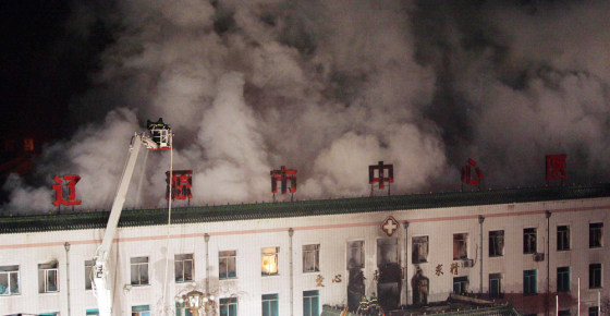 Chinese firemen try to extinguish a fire at Central Hospital in Liaoyuan city