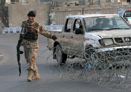 An Iraqi soldier closes off a street in Baghdad on Friday as part of a vehicle ban put in place for recent parliamentary elections.