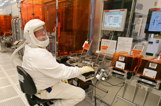An Intel Corp. manufacturing technician produces computer chips in a clean room at Intel headquarters in Santa Clara, Calif., earleir this year. Instead of remaining focused on PCs, Intel is pushing to play a key technological role in a half-dozen fields, including consumer electronics, wireless communications, and health care. 