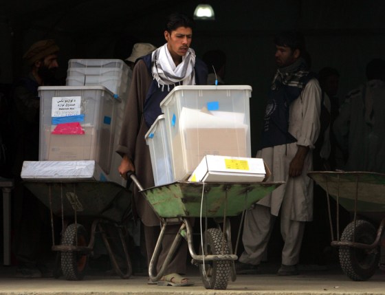 Afghan election workers move ballot boxes into a store in Kabul