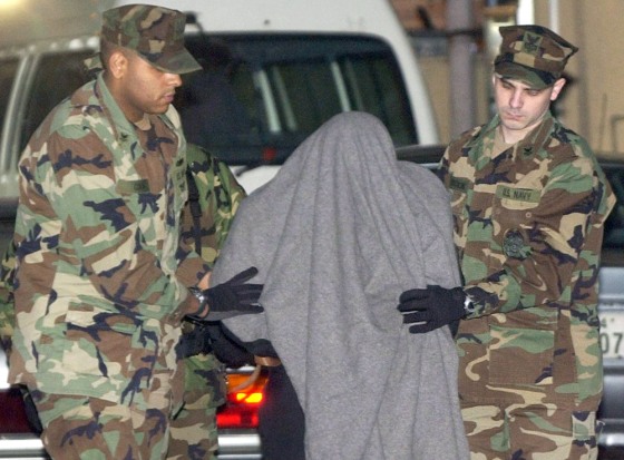 US sailor is escorted by US servicemen to local police station in Yokosuka