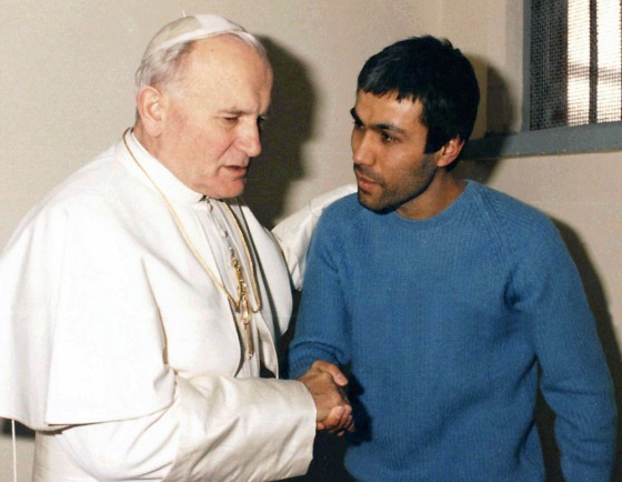 Pope John Paul II converses with his would-be assassin, Mehmet Ali Agca, in Agca's prison cell in Rome in this Dec. 27, 1983 file photo. 