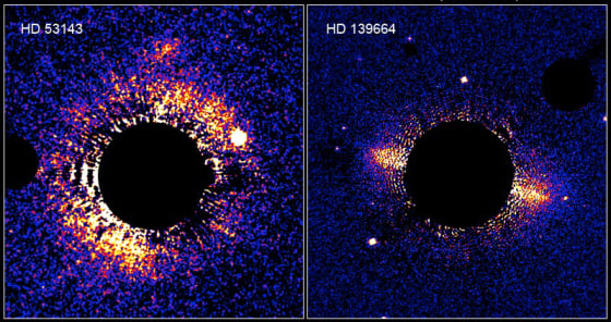 These two bright debris disks of dust and ice, spotted by the Hubble Space Telescope, appear to be the equivalent of our own solar system's Kuiper Disk. In each case, the glare of the central star has been blotted out by a black disk.