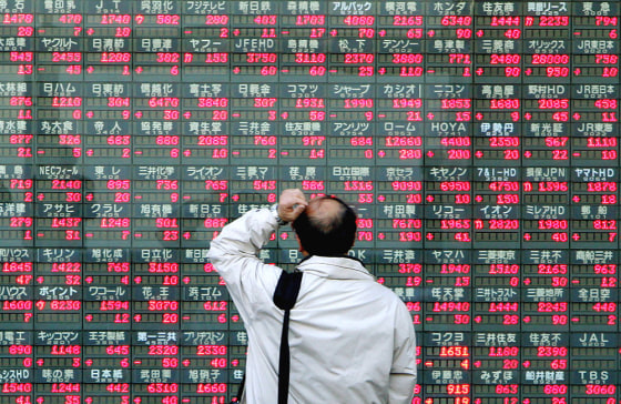 A man looks at an electronic stock quota