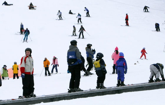 Beginner skiers ride an escalator at Attitash Ski area in Bartlett, N.H., Wednesday, Dec. 28, 2005. 