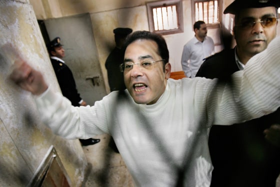 Leading government opponent Ayman Nour shouts to supporters through the bars of the defendant's dock in a Cairo courtroom before being forcibly removed by police, after he was sentenced to five years' imprisonment for forgery in December. The year-long judicial process drew international criticism and uproar.