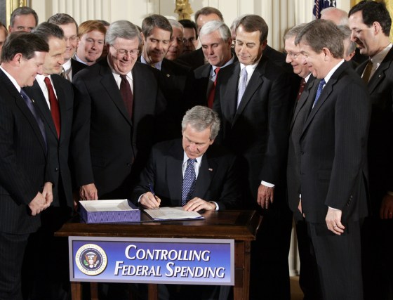 President Bush, flanked by lawmakers, signs legislation Wednesday aimed at trimming Medicaid and Medicare spending over the next five years.