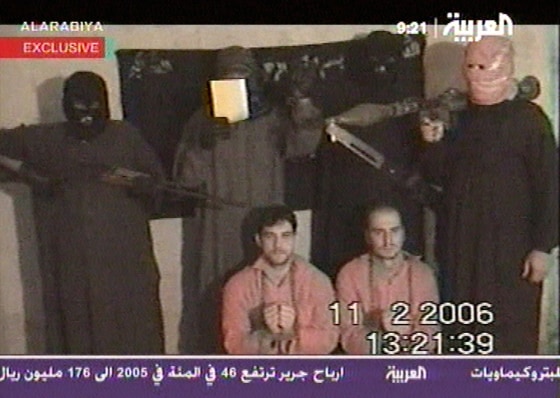 A video aired Monday shows Thomas Nitschke, right, and Rene Braeunlich surrounded by their kidnappers. The two Germans were abducted Jan. 24.