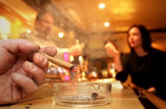 A man ashes his cigar at a pub in Hatfield Heath, Essex, outside of London.