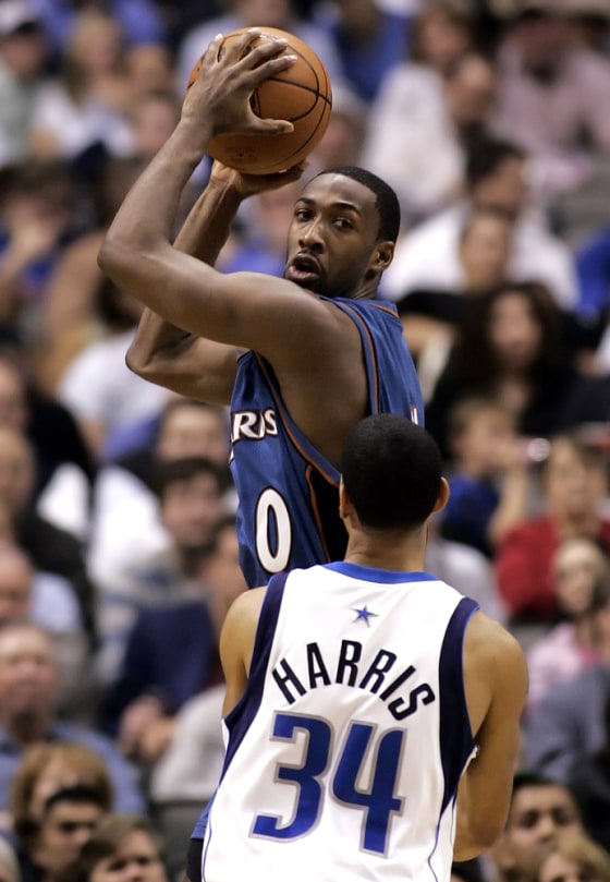Wizards' Arenas catches pass over Mavericks' Harris during first half of their NBA game in Dallas
