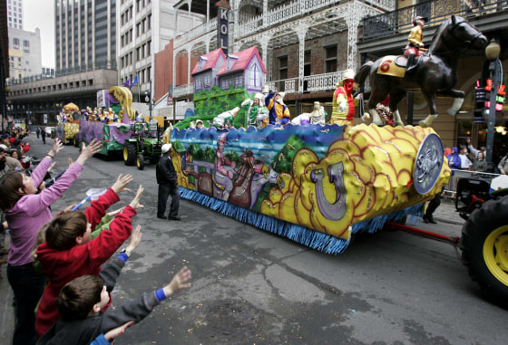 Spectators call for beads from krewe members during the Pegasus Mardi Gras parade in New Orleans