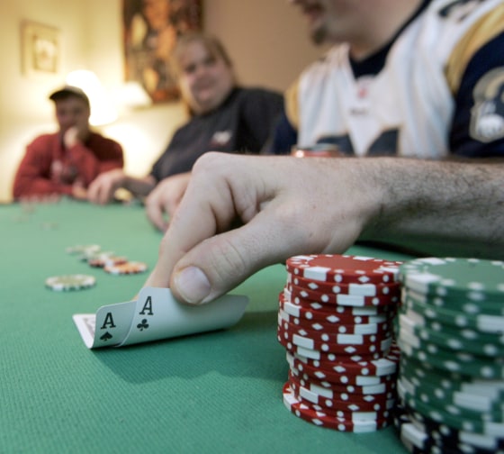 Players take part in a poker night in a house in Prince William County. Here, a player shows his hand in Texas Hold ' Em.
