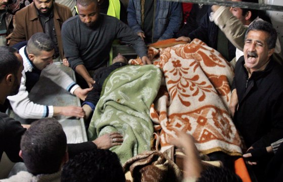 The bodies of two members of the Al Aqsa Martyrs Brigades are brought into a hospital in Nablus on Thursday, after the men were slain by Israeli troops in the nearby Balata refugee camp.