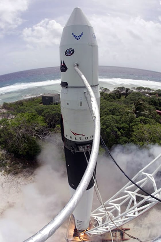 The Falcon 1 rocket's engine fires briefly during a static-fire test on SpaceX's launch pad in Kwajalein Atoll.