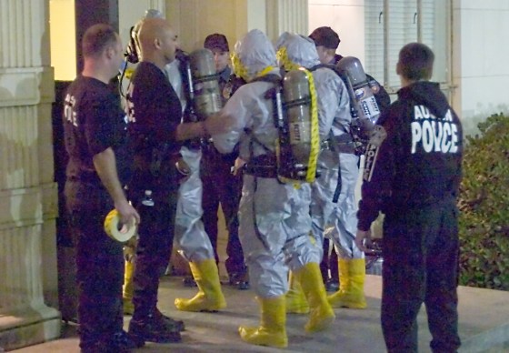 Members of the Austin Fire Department Special Operations Hazardous Materials Regional Strike Team enter Moore-Hill Dormitory to investigate the presence of ricin, a toxin that was discovered by a Moore-Hill resident Thursday in a roll of quarters.