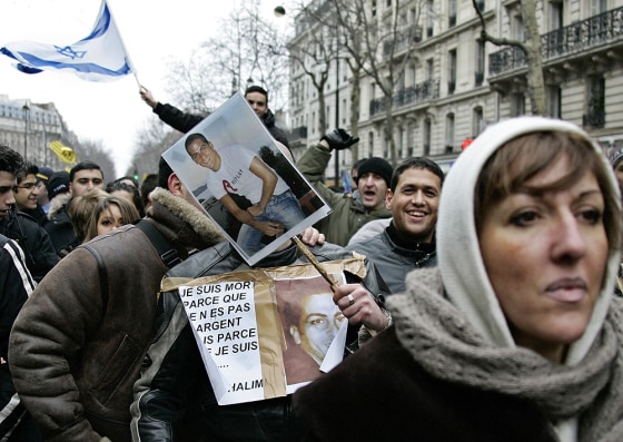 Demonstrators carry photographs of Ilan Halimi on Sunday as they march through Paris to show their opposition to racism and anti-Semitism after his torture and murder.