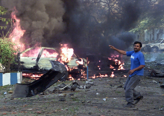 A Pakistani man calls for help after an explosion near U.S. consulate in Karachi