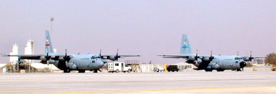 In a secretive operation, heavily armed gunship versions of C-130 transport planes like these at an airbase in southern Iraq, on Wednesday, are being shipped to Iraq.