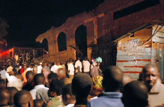 People gather Wednesday to examine the ruins of a church after the roof collapsed during a service in Kampala, Uganda.