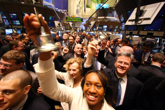 Nicolette Martin, center, and members of the NYSE ring bells to celebrate Wednesday’s opening bell as the Big Board became a publicly-listed company after 213 years as a not-for-profit member-owned club.