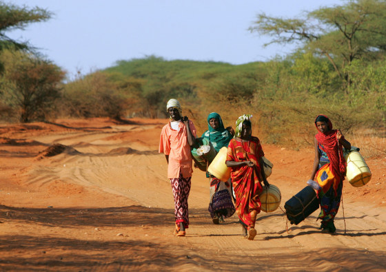 Kenyans with plastic containers search for water along road in Wajir northeastern Kenya