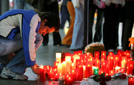 A man pays his respects at a memorial site for the victims of the March 11 train bombings at Atocha station in Madrid