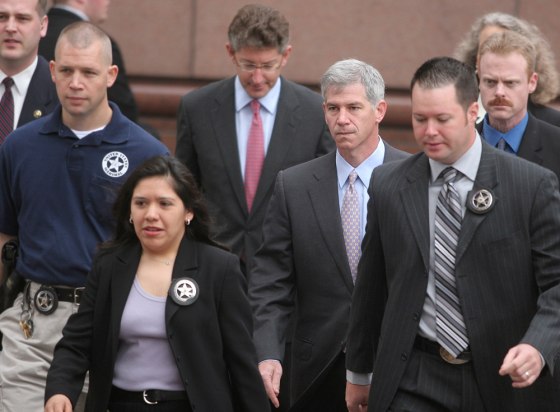 Former Enron Chief Financial Officer Andrew Fastow is surrounded by US Marshalls as he arrives with his attorney David Gerger at the Federal courthouse in Houston