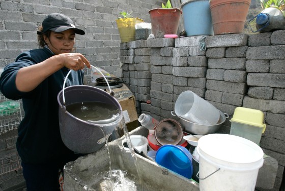 After waiting for five hours at a water distribution center to get her weekly ration, Raquel Villanueva prepares to wash her dishes at her home in Mexico City on March 9.