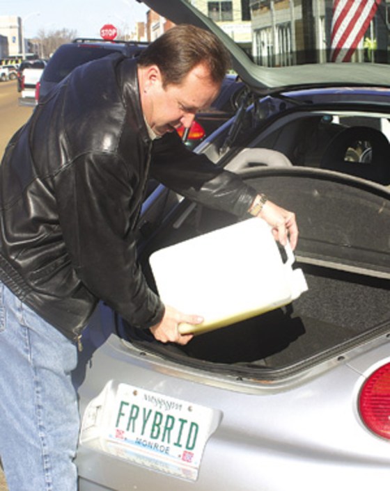 Robert Tomey fills his diesel Volkswagen with biodiesel made from the leftover grease at McDonald's franchises that he owns.