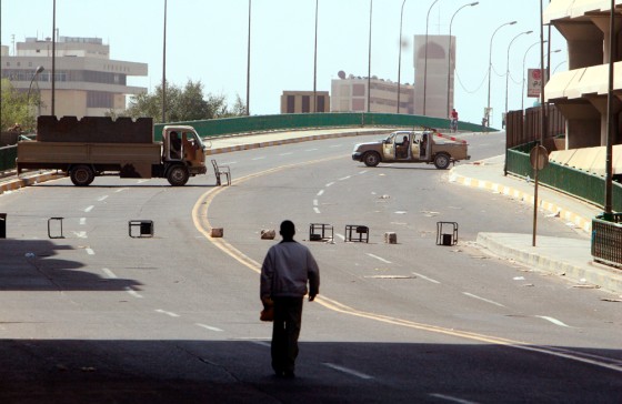 Iraqi army soldiers in vehicles guard a street during a car ban aimed at preventing bombings during parliament's swearing-in, on Thursday, in Baghdad.
