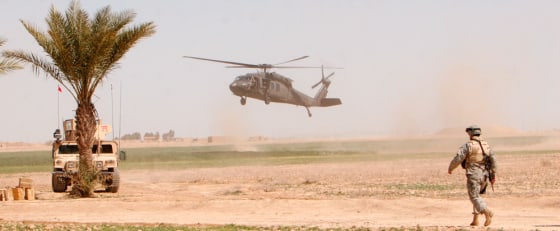 A U.S. helicopter lands as a U.S. soldier stands guard outside Samarra, Iraq, Friday, during Operation Swarmer.