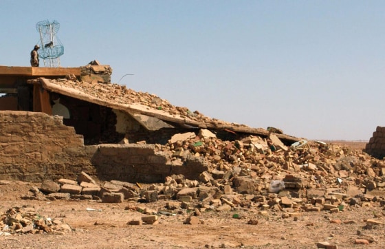 Iraqi soldier stands guard on top of toppled mosque outside Samarra
