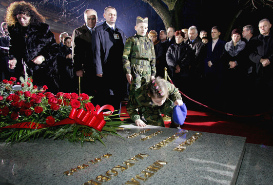Sympathizers pay respects Saturday at the grave of former Yugoslav President Slobodan Milosevic in his hometown of Pozarevac.