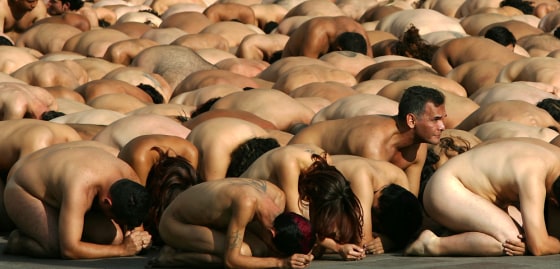 Nude volunteers prepare to pose for a photograph by American artist Spencer Tunick in downtown Caracas on Sunday.