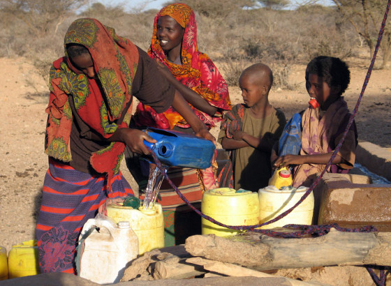 Somali girls collect water at a well in Wajid region in southern Somalia