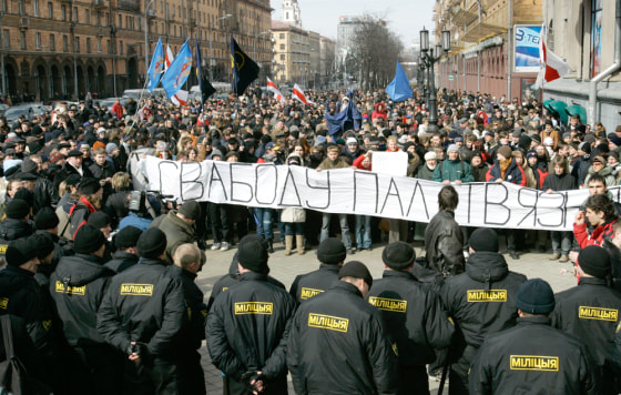 Riot police confront oppositon supporters during a demonstration in Minsk, Belarus, on Saturday. The banner reads "Freedom for political prisoners."