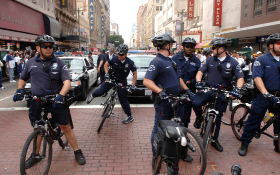 Police prepare as thousands take to the streets for a pro-immigrant march and rally in Los Angeles