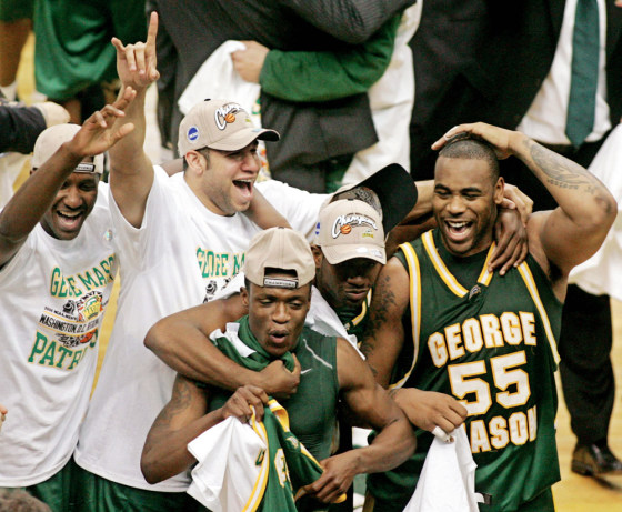 George Mason University's Lewis and Skinn celebrate with teammates after defeating the University of Connecticut in Washington