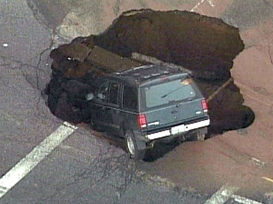 The SUV rests in the Brooklyn street sinkhole.