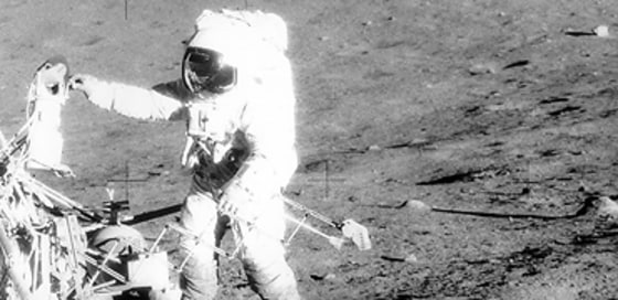 During the Apollo 12 mission in 1969, commander Pete Conrad retrieves equipment from the Surveyor 3 probe, which landed on the moon three years earlier. This picture, taken by astronaut Alan Bean, shows Apollo 12's lunar module in the far distance. Future lunar missions may locate similar leftovers, for scientific as well as historical purposes.