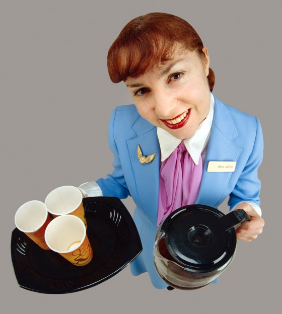 Flight Attendant Offering Coffee