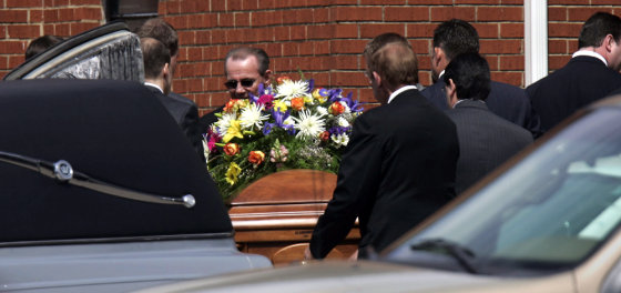 Pall bearers remove the casket bearing the body of pastor Matthew Winkler from the hearse to carry it into the church for his funeral service in Selmer, Tenn. on Tuesday.