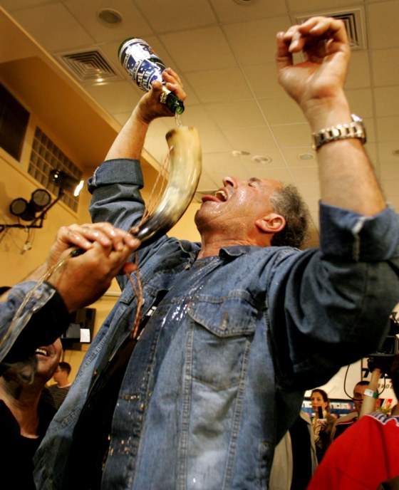 An Israeli Labor party supporter drinks champagne in Tel Aviv