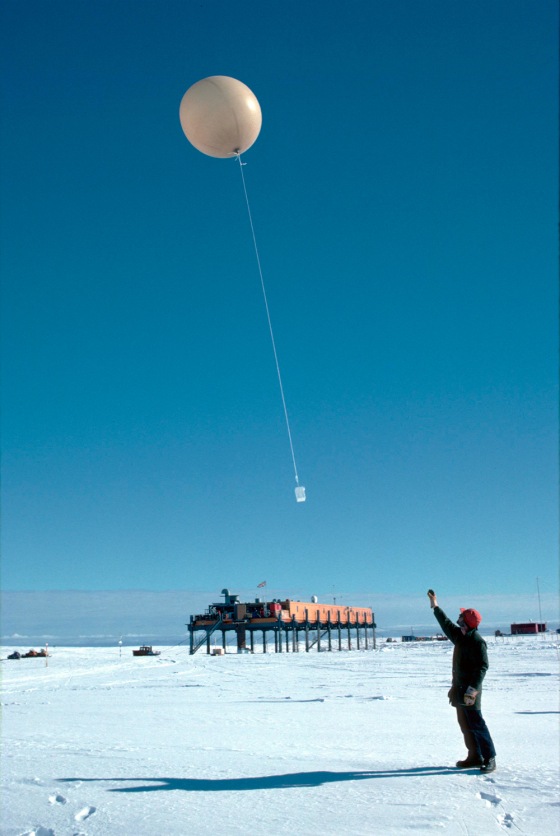 A researcher launches a weather balloon from the British Antarctic Survey's Halley Research Station. 